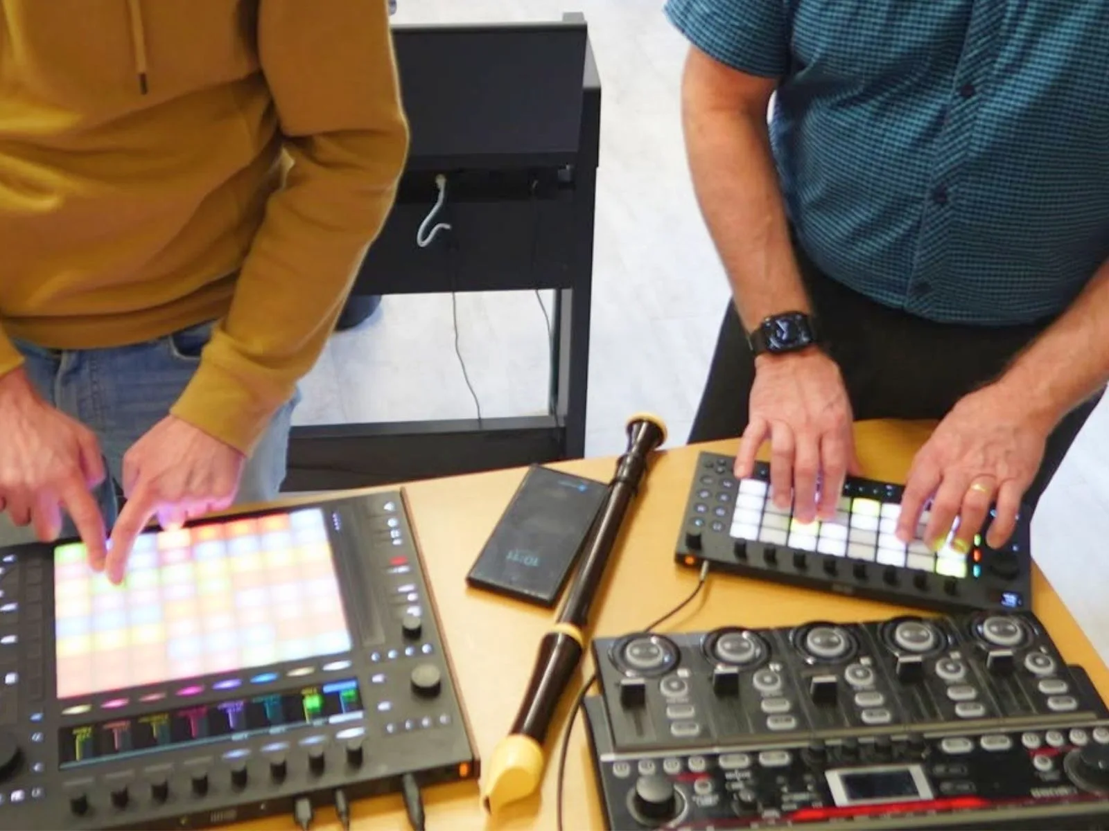 Učitel pracuje s tabletem, kytarou a looperem ve zkušebně